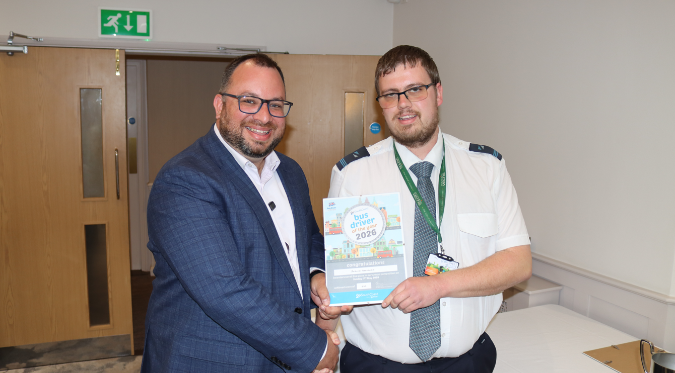 Joshua Scrivener being presented a certificate by commercial director David Lee-Kong