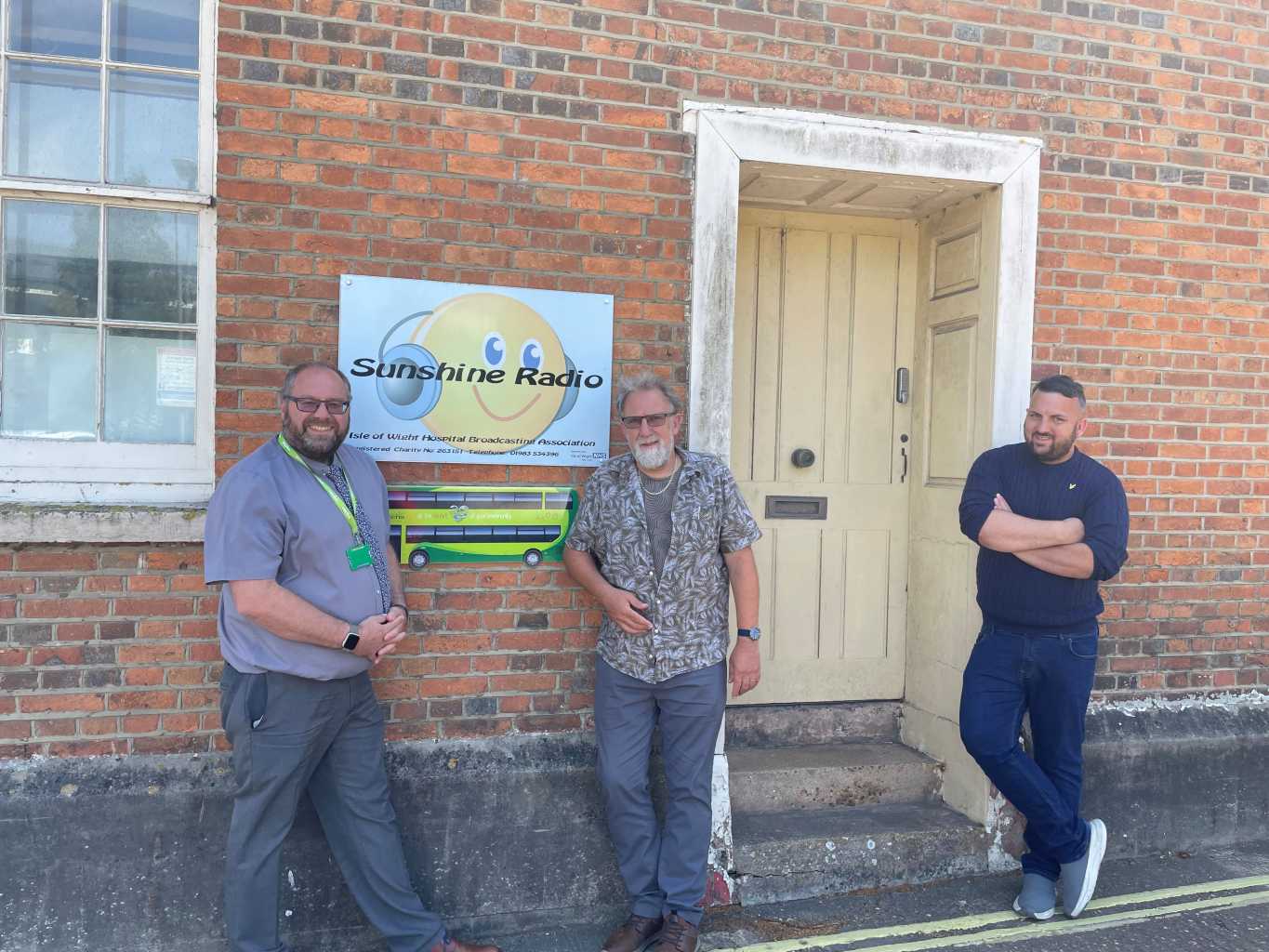 sunshine radio team stood in front of door